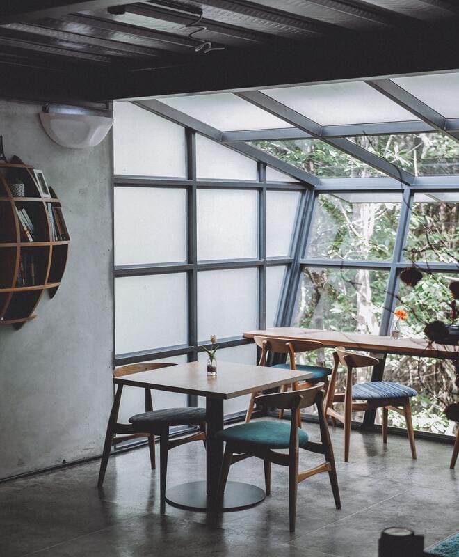 Sala com mesa de madeira e janela de vidro